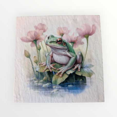 A green frog sitting on a lily pad among pink water lilies.