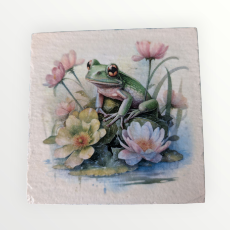 A green frog sitting among pink and white flowers on a tranquil pond.
